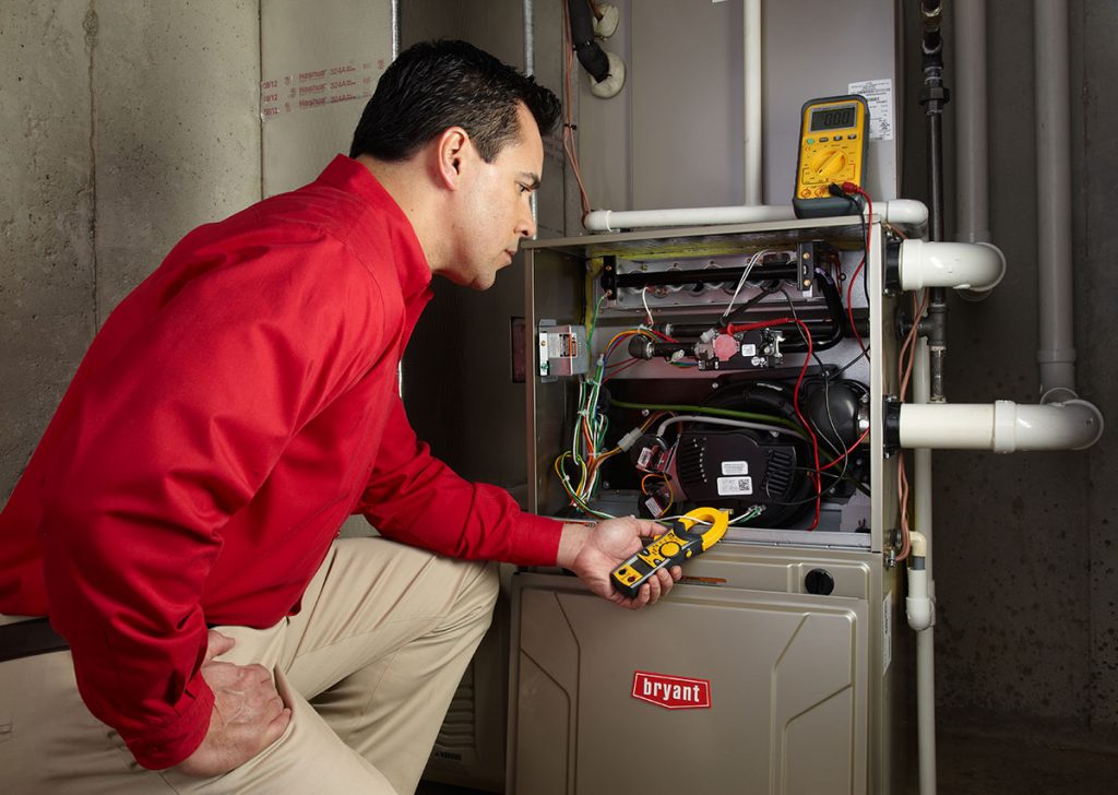 Heating technician diagnosing a furnace repair in Dana Point
