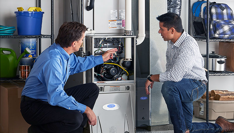 Technician evaluating a furnace for repair or replacement in Dana Point