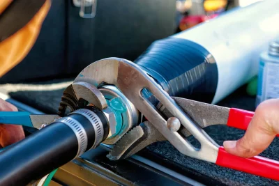 Technician repairing an industrial pipe connection in Dana Point
