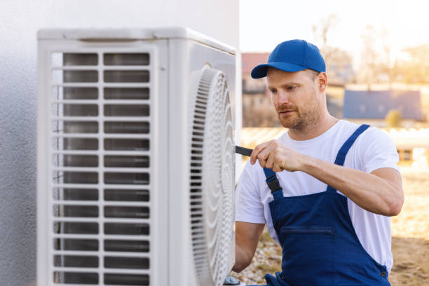 HVAC technician servicing an outdoor air conditioner in Dana Point
